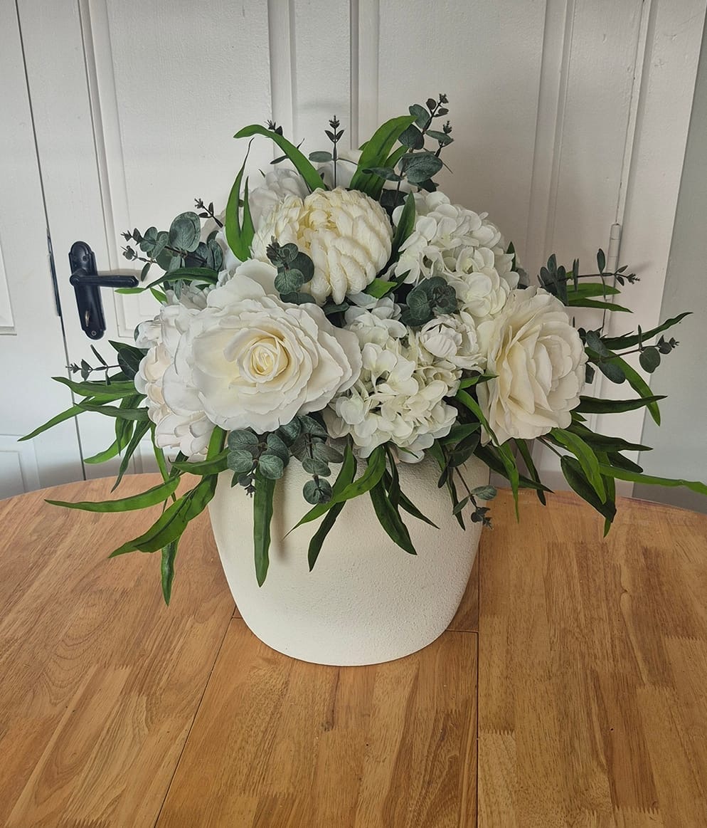 White floral arrangement in elegant pot centerpiece
